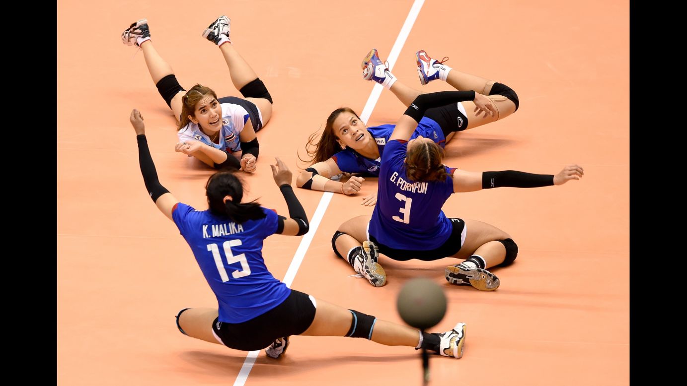 Thai volleyball players dive on the court during an Olympic qualifying tournament on Saturday, May 21. Thailand defeated South Korea, but it was South Korea that would eventually advance to Rio de Janeiro.