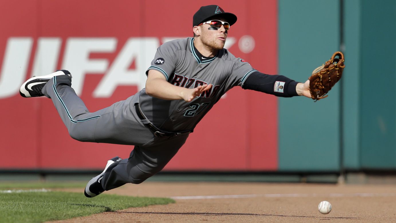 Arizona right fielder Brandon Drury is unable to make the catch after diving for a foul ball in St. Louis on Saturday, May 21.