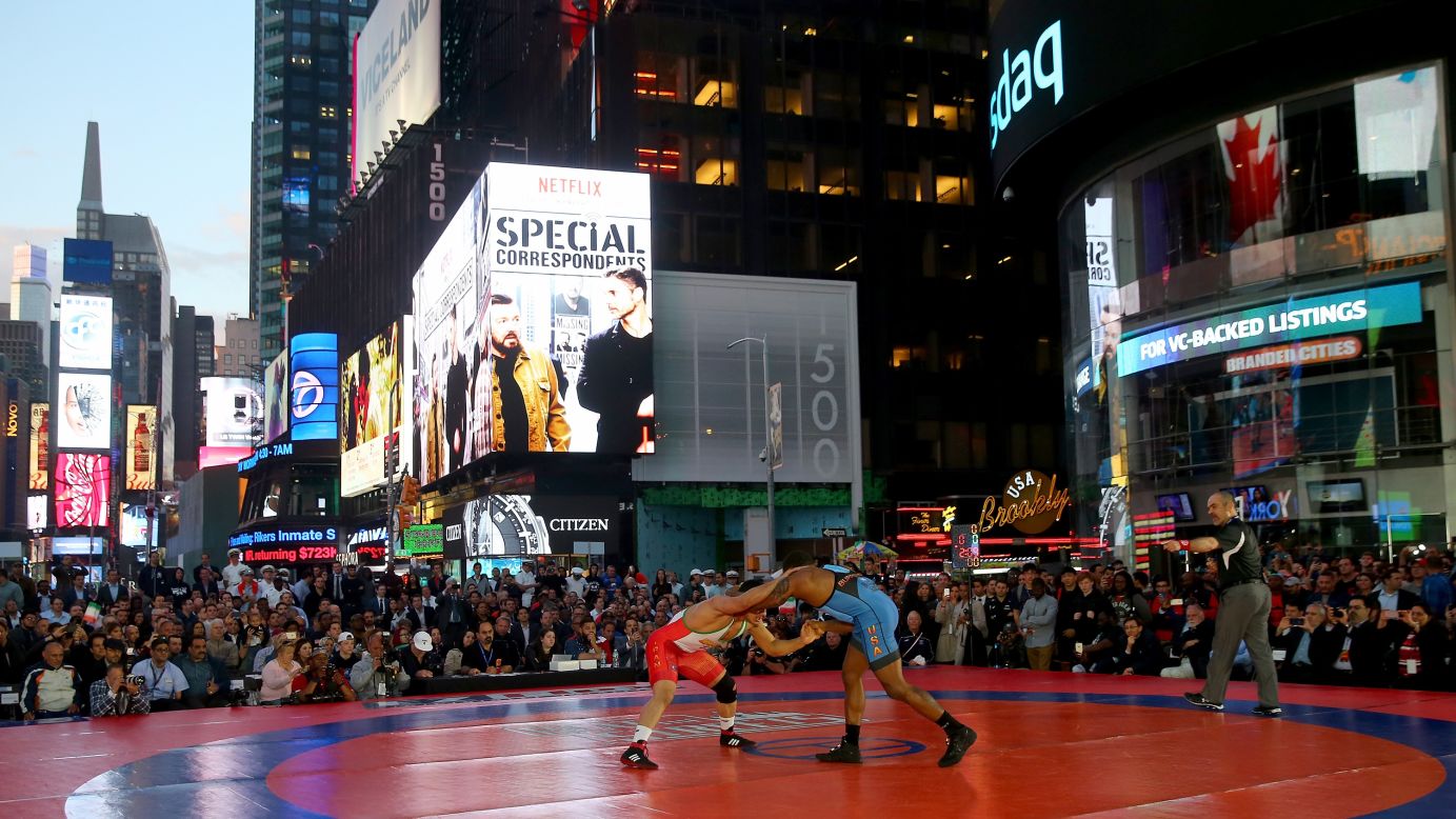 Iran's Peyman Yarahmadi, left, takes on American Jordan Burroughs during a wrestling event in New York's Times Square on Thursday, May 19.