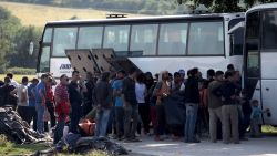 People board in a bus in order to leave the refugee and migrant makeshift camp on the Greek-Macedonia border near the village of Idomeni on May, 23 2016.
Greece said on May 23 it will step up efforts to clear the squalid camp of Idomeni where over 8,400 migrants remain on the border with Macedonia after braving a winter in vain hope of being allowed through to Europe. / AFP / SAKIS MITROLIDIS        (Photo credit should read SAKIS MITROLIDIS/AFP/Getty Images)