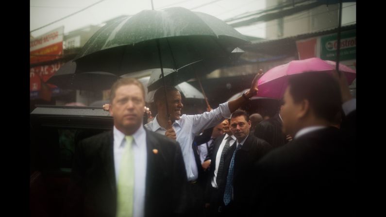 Obama waves to locals during a visit to a shopping district in Hanoi, Vietnam, on May 24.