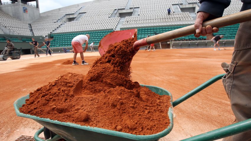 Employees set the last layer of clay on the Suzanne Lenglen court on May 7, 2012 at the Roland Garros tennis stadium in Paris, where the French Open tennis tournament will run from May 22 to June 10, 2012. AFP PHOTO JACQUES DEMARTHON        (Photo credit should read JACQUES DEMARTHON/AFP/GettyImages)