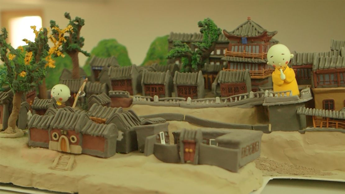 Longquan Temple's animation studio created these models of the temple and monks with light clay. The temple gives monk dolls to tourists as souvenirs.