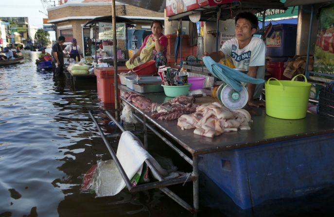 Vendors wait for business at a floating market in Bangbuathong, Thailand.