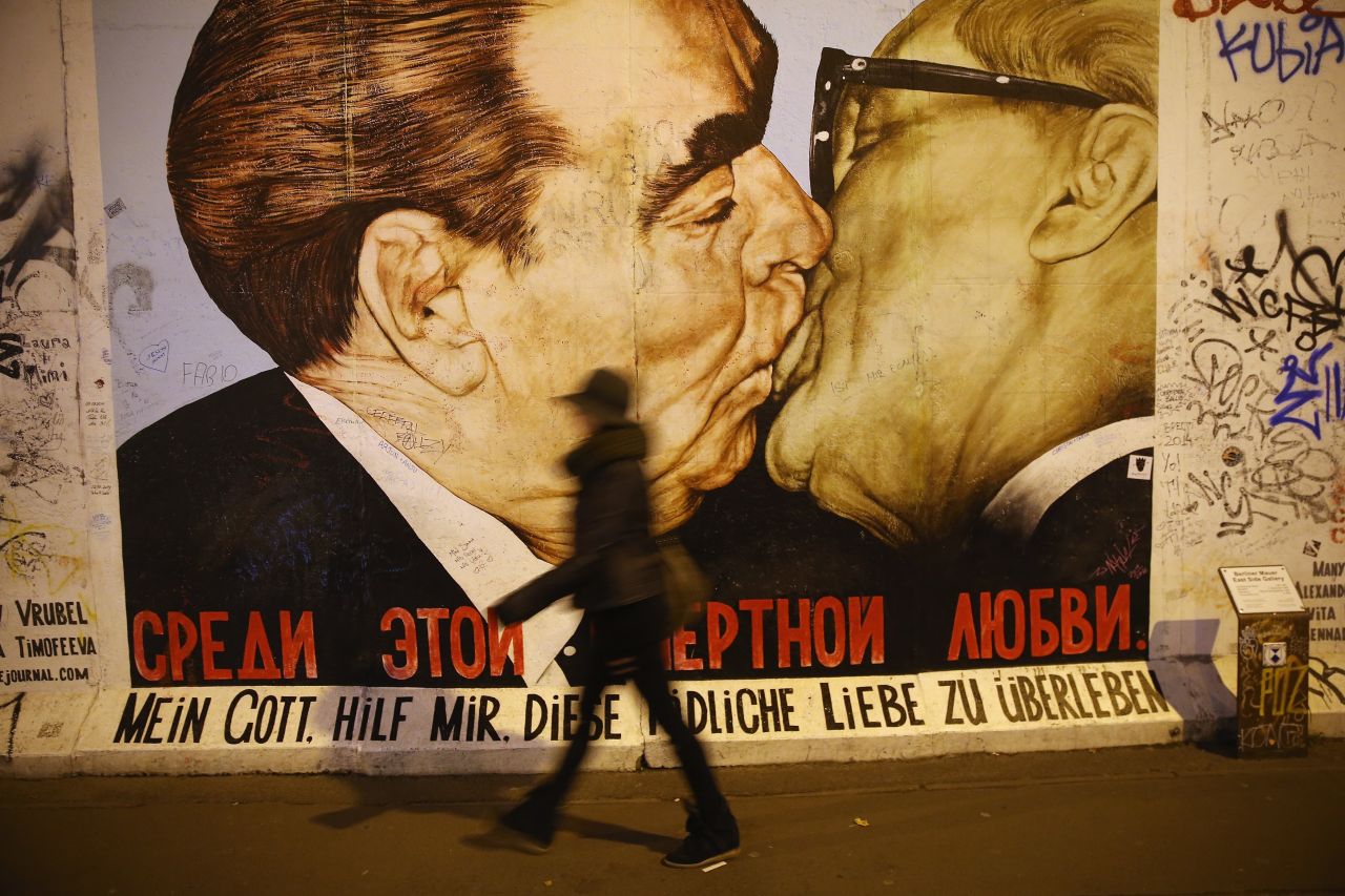 The mural is a play on a famous work of art on the Berlin wall depicting Soviet leader Leonid Brezhnev and East German leader Erich Honecker sharing a kiss. The message below reads: "My God, help me survive this deadly love."