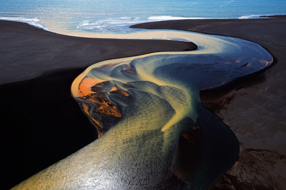Stephen King submitted this aerial shot from a helicopter over southern Iceland. "The brilliant colors are a result of mineral deposits picked up by the glacial waters as they flow toward the sea," he says. (<a href="http://travel.nationalgeographic.com/photographer-of-the-year-2016/" target="_blank" target="_blank">Click here to enter NatGeo photo contest</a>)