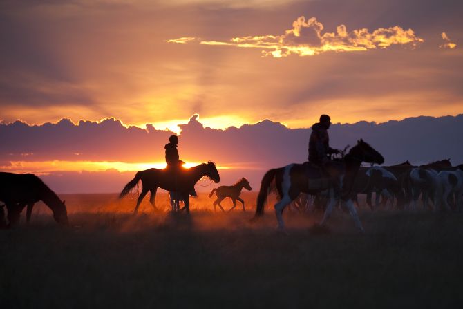 Kazakh horsemen drive their herd to a corral where they'll spend the night being guarded against horse thieves. Ryan Bell says he took this image about 100 miles from the site in Kazakhstan where archeologists have discovered the oldest-known remains of a domesticated horse. (<a href="http://travel.nationalgeographic.com/photographer-of-the-year-2016/" target="_blank" target="_blank">Click here to enter NatGeo photo contest</a>)
