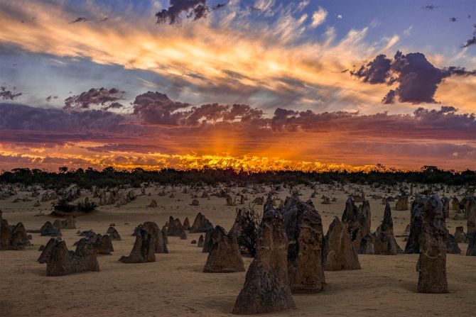 Sam Yick captures a moment of fiery light over the stark landscape of the Pinnacles rock formations in Western Australia. (<a href="http://travel.nationalgeographic.com/photographer-of-the-year-2016/" target="_blank" target="_blank">Click here to enter NatGeo photo contest</a>)