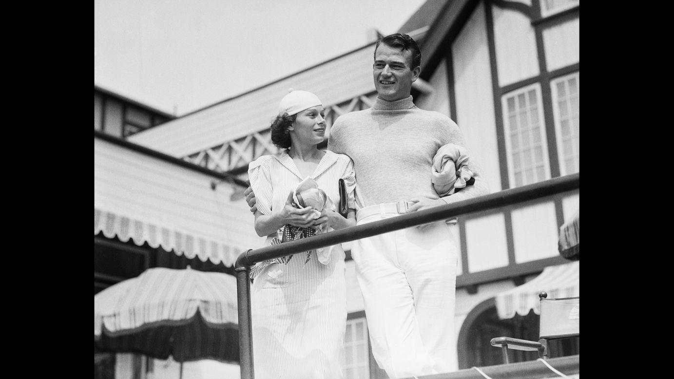 Wayne spends time with his new wife, Josephine, at an exclusive swimming club in Santa Monica, California, in 1933.