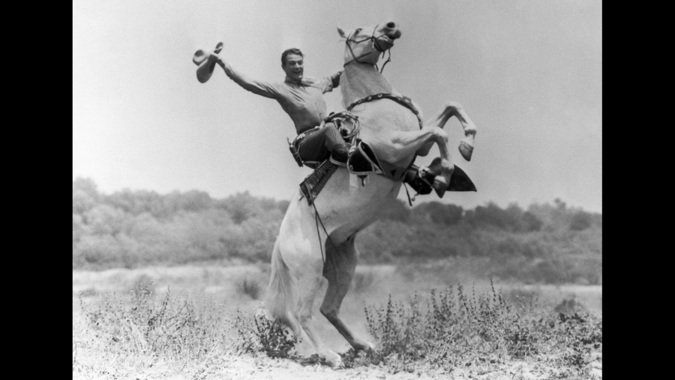 Wayne rides a horse in 1935.