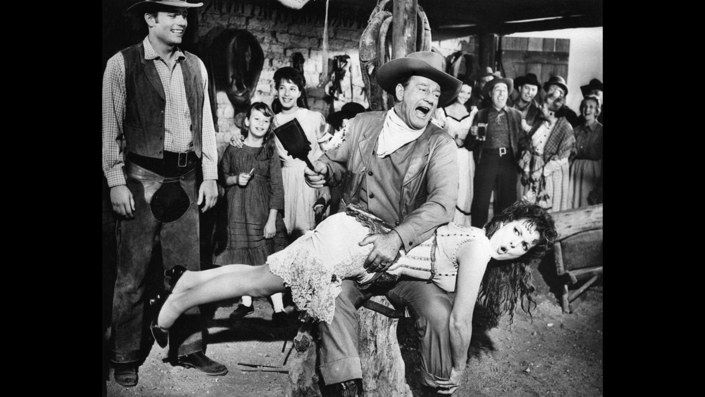 Wayne spanks actress Maureen O'Hara, playing his wife Katherine, in the 1963 Western-comedy "McLintock!" "Some captious critics complained over the years that Mr. Wayne did not act, that he only played himself," Weil wrote in the Washington Post. "It scarcely mattered. The public liked the roles he played on the screen and they liked Mr. Wayne off the screen, seeing the film character and the public figure as one and the same -- gruff, good-humored, plainspoken and admirable."