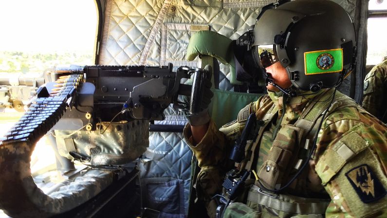 A helicopter gunner keeps watch over Taji, Iraq, as CNN flies into the next location. 