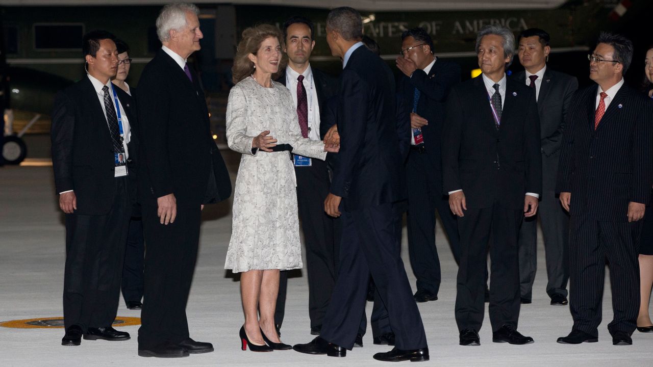 Obama is greeted by U.S. Ambassador to Japan Caroline Kennedy and her husband, Edwin Arthur Schlossberg, at the airport in Tokoname, Japan, on May 25.
