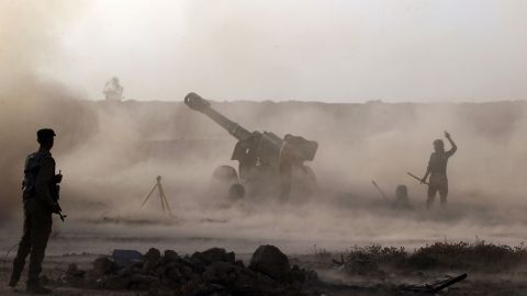 Iraqi Shiite fighters fire artillery near Falluja on May 23.