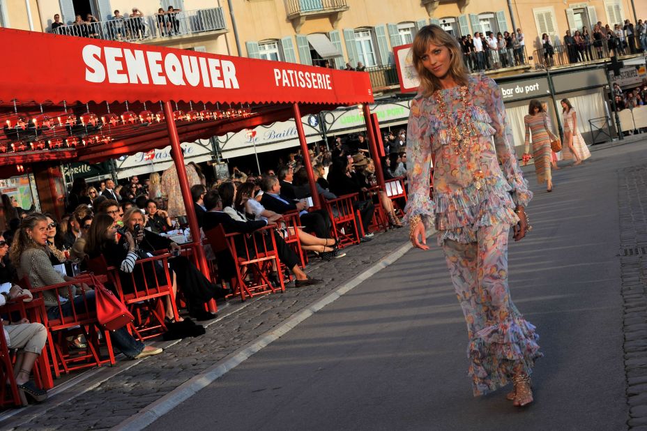 Not even a volcanic ash cloud could stop Karl from staging yet another glamorous Cruise collection, this time in sunny St. Tropez. Models disembarked from boats before walking a runway at sunset in front of Sénéquier, the iconic cafe with endless rows of red director's chairs for guests to sit on.