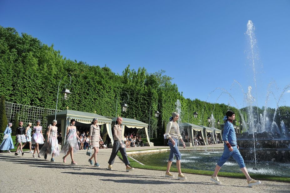 After weeks of rain, the sun shone on Lagerfeld's 2013 collection. It was staged around the fountains at Versailles, in a section never open to the public -- naturally.