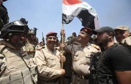 Iraqi forces celebrate the recapture of the town of Karma from ISIS.