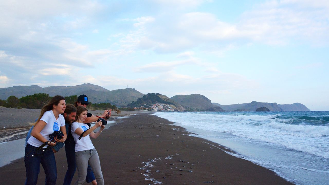 Local business owner Yiorgos Eleftheriou shows off a stretch of Skala Eressos beach to Travel Bloggers Greece members Elena Sergeeva, Chrysoula Manika and Amber Charmei.