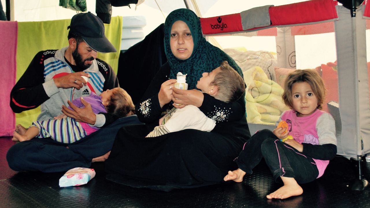 Alyaman Daar lies in the arms of his mother, Johaina, surrounded by the rest of his family.