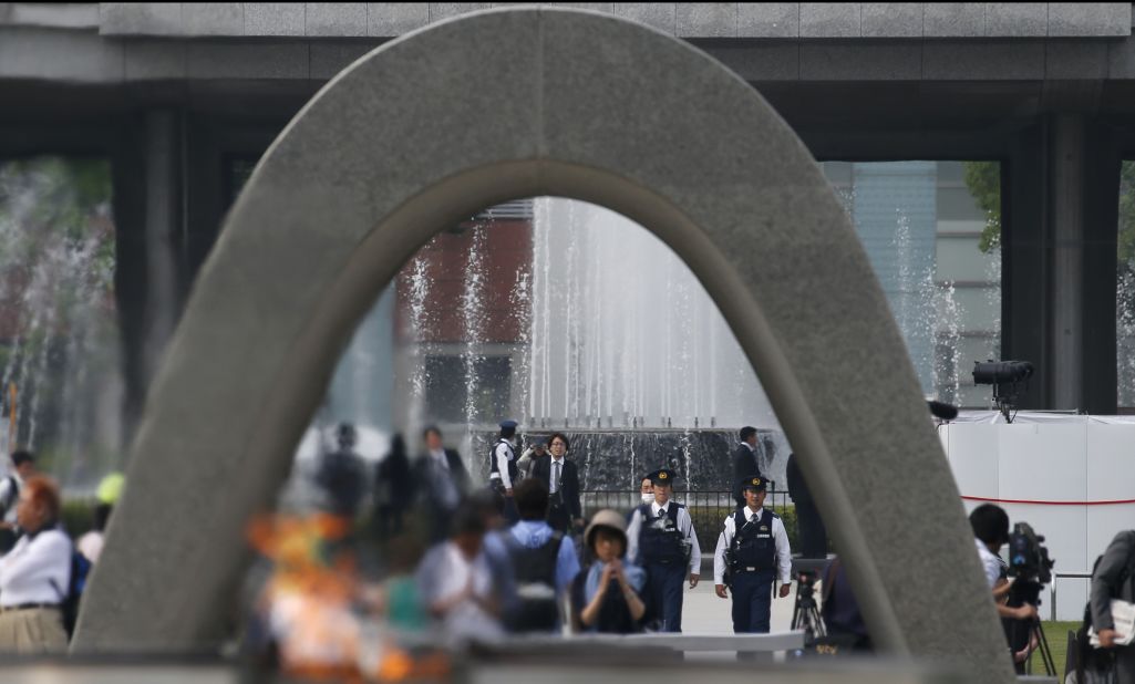 Police officers, seen through the cenotaph, patrol at Hiroshima Peace Memorial Park in Hiroshima.