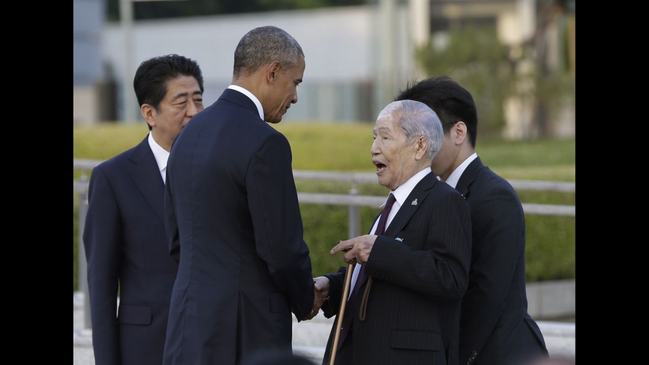 President Obama, center, accompanied by Japanese Prime Minister Shinzo Abe, left, shakes hands and talks with Sunao Tsuboi, a survivor of the 1945 atomic bombing and chairman of the Hiroshima Prefectural Confederation of A-bomb Sufferers Organization (HPCASO), at Hiroshima Peace Memorial Park in Hiroshima, western Japan.