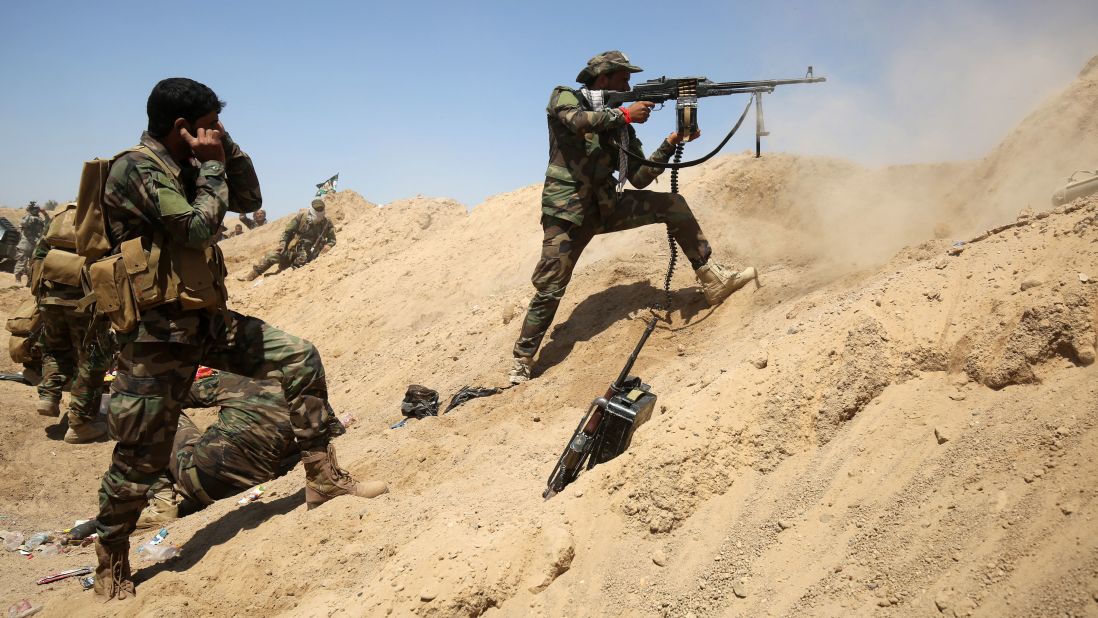 Iraqi government forces engage with ISIS fighters near the village of al-Sejar on Thursday, May 26.