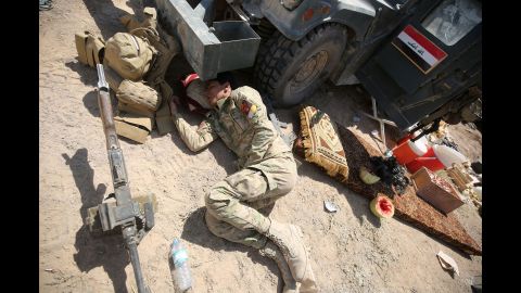 A pro-government fighter rests after battling ISIS near al-Sejar on May 26.