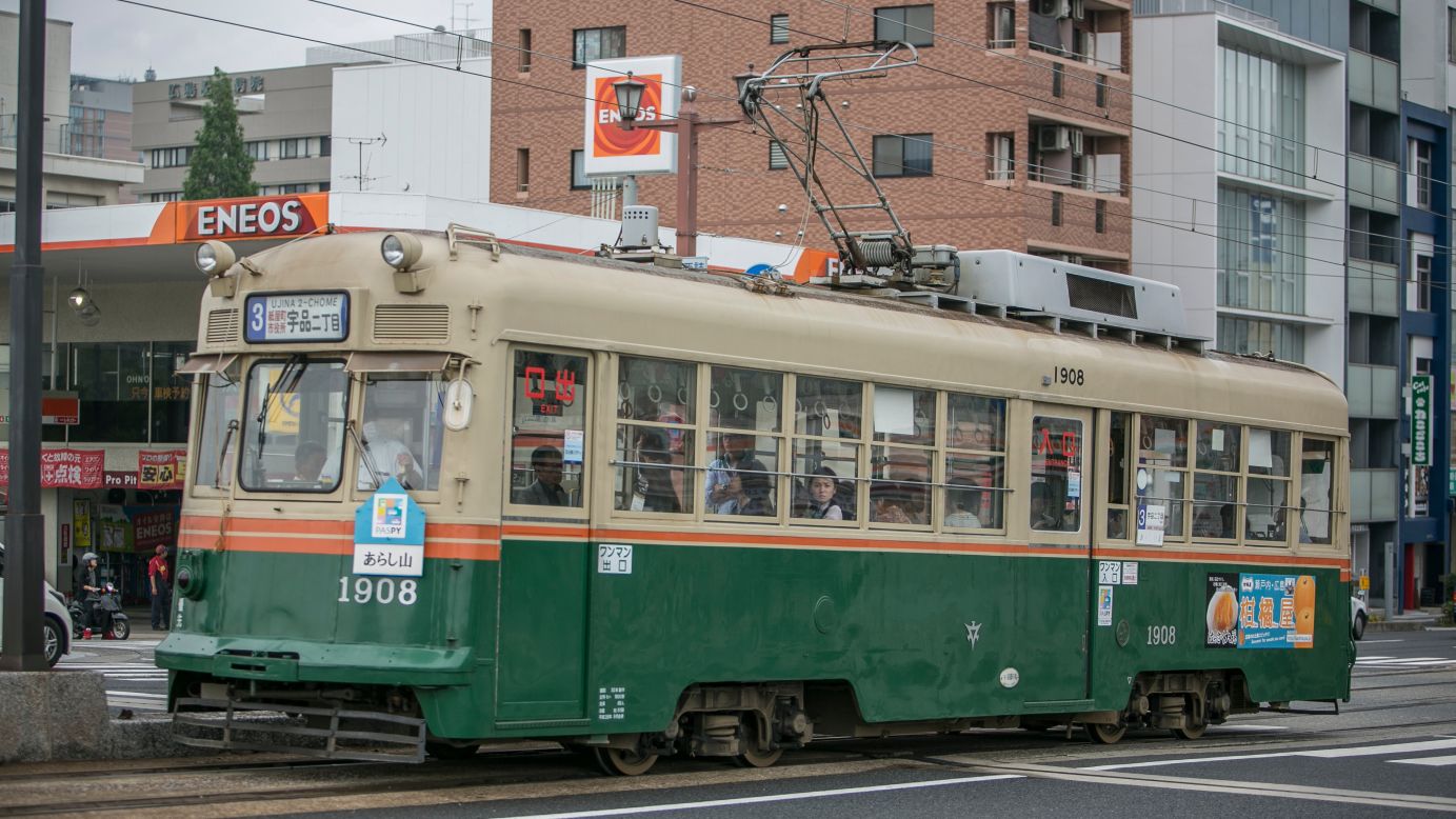 <strong>Now: </strong>People ride a trolley car on May 26.
