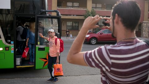Yordanis Garcia Milian, 28, snaps a photo of his brother, Yani Garcia Milian, 38, as they prepare to board a bus in El Paso and begin their journey to meet family in Melbourne, Florida. 