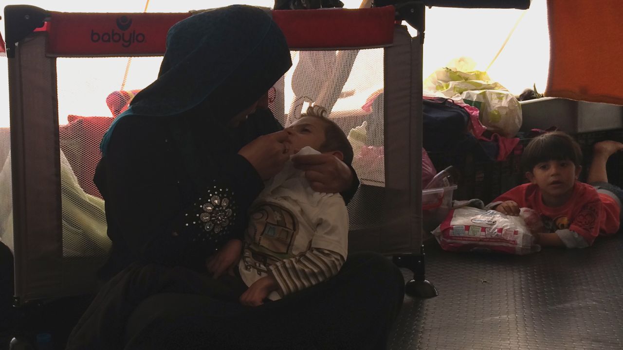 Johaina Daar talks tenderly to her son Alyaman while feeding him with a syringe.