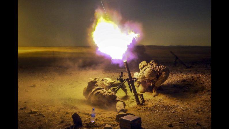 Marine Lance Cpl. Zach King, left, and Cpl. Derick Sammonek brace themselves as they fire a mortar during a training exercise in Jordan on Sunday, May 15.