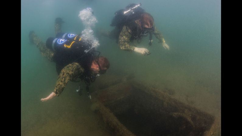 Steel Worker 1st Class Jesse Hamblin, left, and Builder 2nd Class Justin Lieder examine a ladder well of the USS Arizona on Friday, May 20. The battleship was sunk during the attack on Pearl Harbor in 1941.