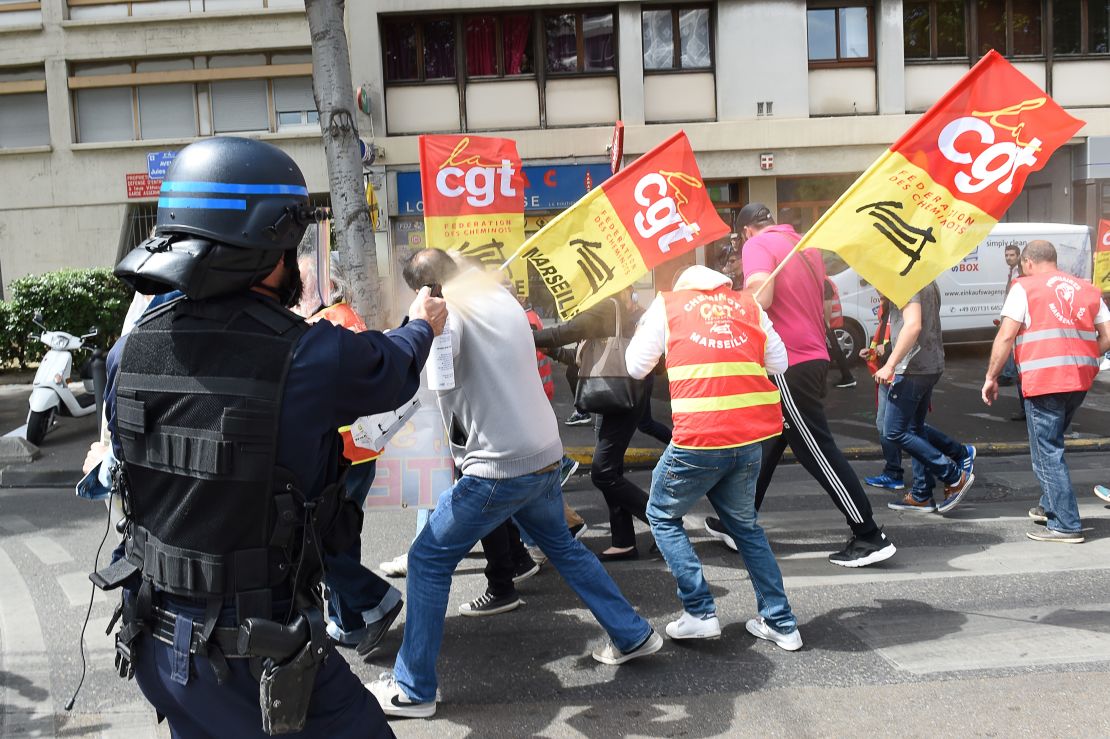 A riot police officer uses pepper spray on protestors in Marseille, France, at a rally against government's proposed labor law reforms, on May 25.