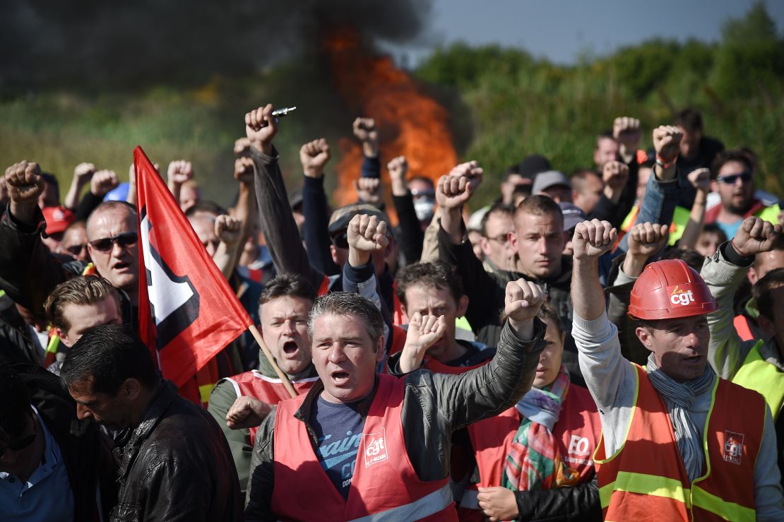 Workers strike and block access to an oil depot near the Total refinery in Donges, western France, on May 27 as the government proposes labor reforms that will tighten workers' rights. 
