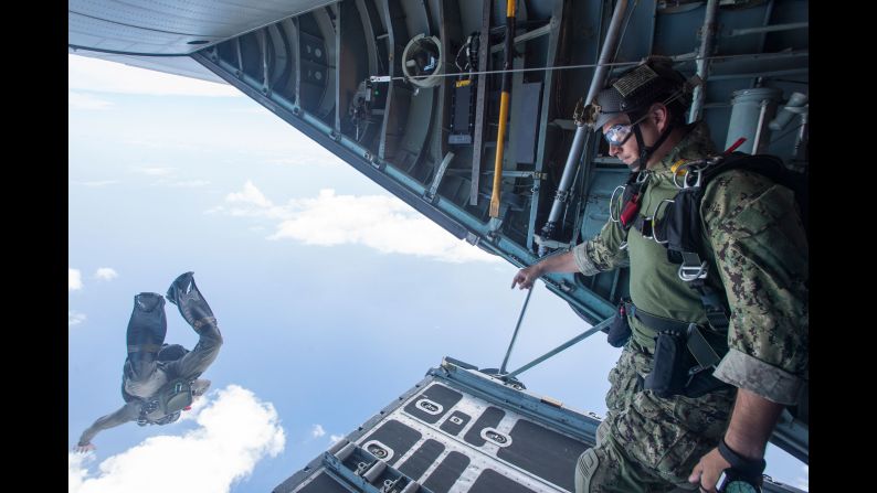 Members of the U.S. Navy jump from a C-130 Hercules during an exercise off the coast of Guam on Wednesday, May 18.