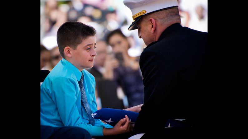 Ethen Lyon, son of Marine Staff Sgt. David Lyon, receives a folded flag during a memorial service at Florida's Eglin Air Force Base on Saturday, May 7. Ethen's father was killed in Afghanistan while serving as an explosive-ordnance disposal technician.