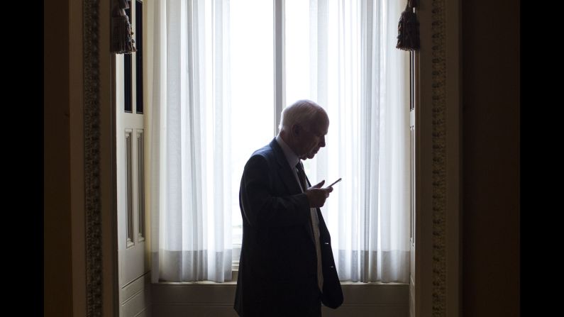 U.S. Sen. John McCain talks on his phone as he steps off the Senate floor in Washington on Wednesday, May 25.