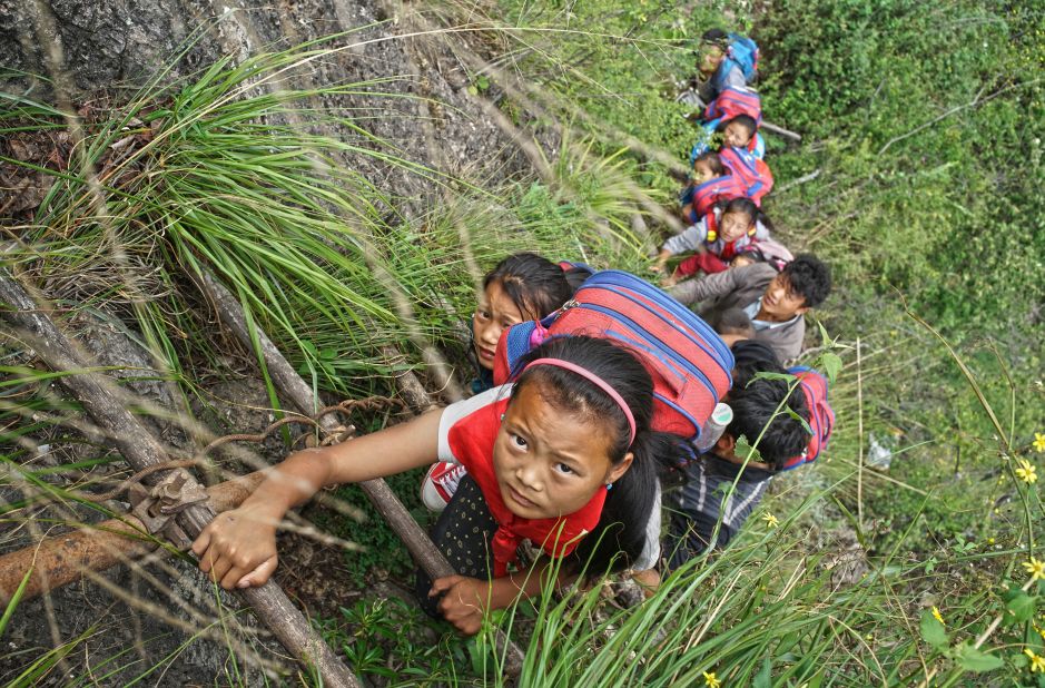 Fifteen children ages 6 to 15 go to school at the foot of a mountain. They make the journey climbing the unsteady "sky ladders," as locals call them.