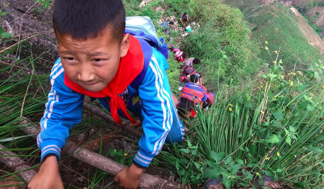 The children don't seem frightened by the descent down the cliff,  Beijing News photographer Chen Jie says.