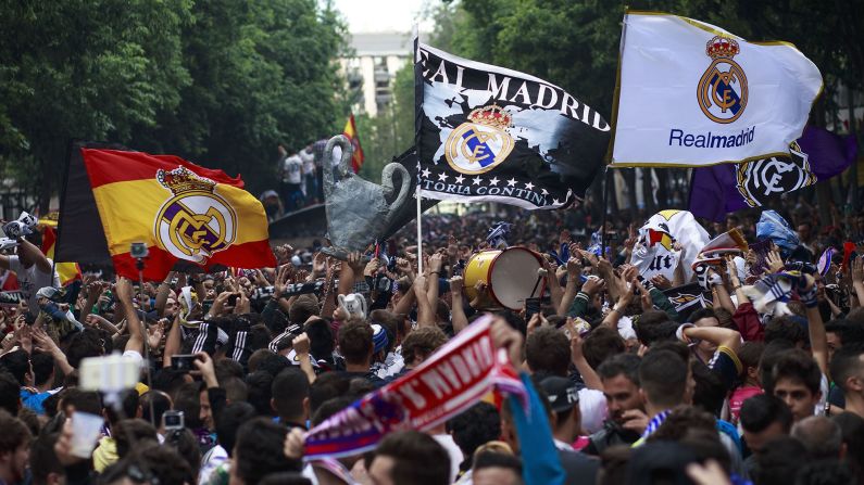 Real Madrid fans cheer for their team outside the Santiago Bernabeu stadium before the UEFA Champions League Final match between Real Madrid and Atletico Madrid.
