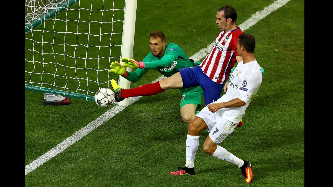 Atletico Madrid's Jan Oblak and Diego Godin combine to stop a chance on goal by Cristiano Ronaldo.