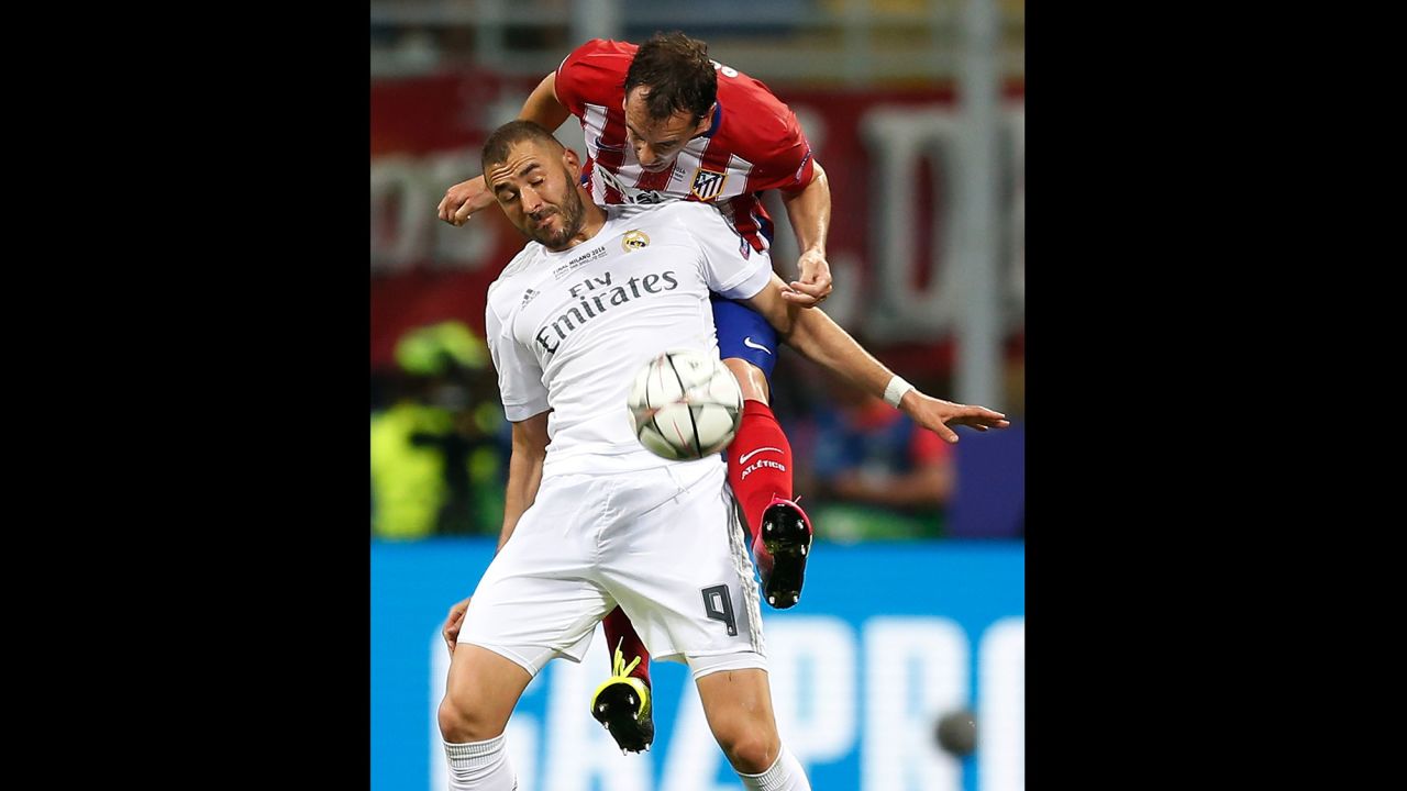 Atletico's Diego Godin challenges Real Madrid's Karim Benzema.