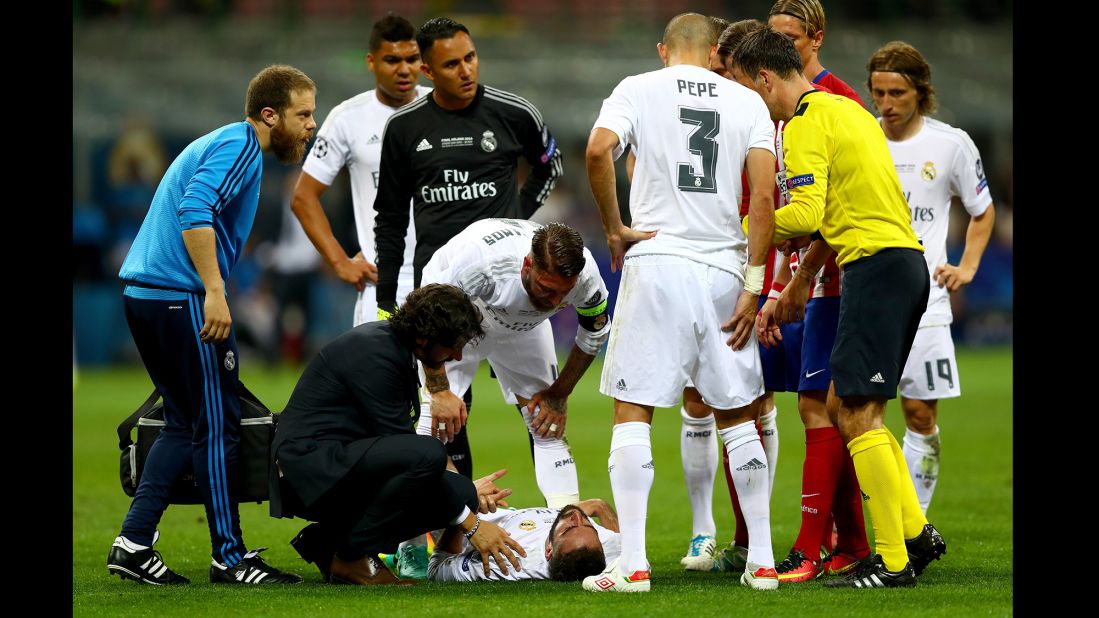 Dani Carvajal of Real Madrid lies injured on the pitch.