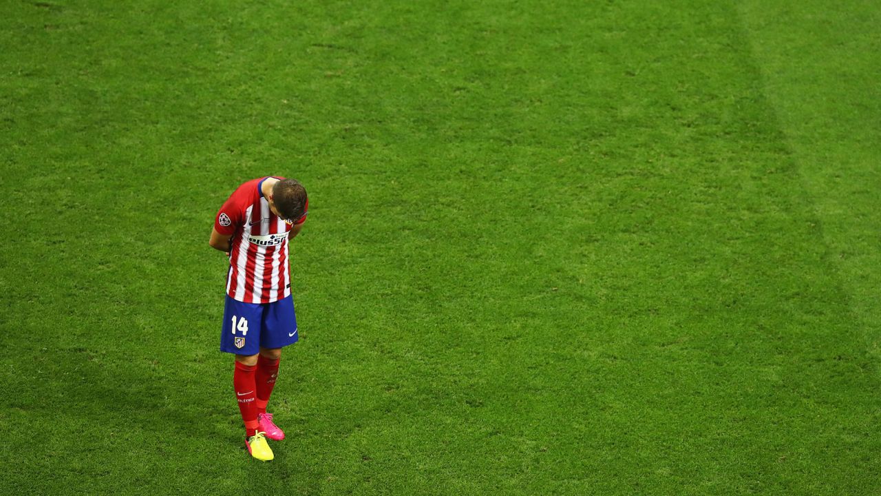 Gabi of Atletico Madrid stands on the pitch after his team lost.  