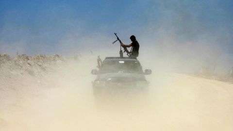 A fighter from a Shiite militia takes a combat position outside Falluja on May 23.