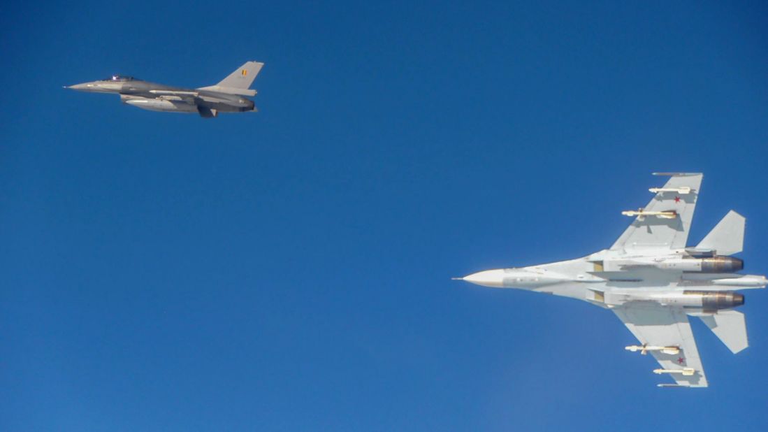 A Russian Su-27 turns away from a Belgian F-16.