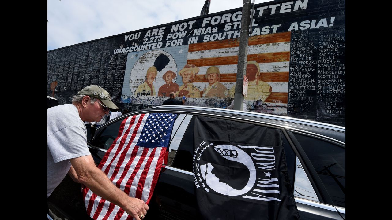 Veterans and other community members help clean up a veterans memorial in Venice Beach, California, on May 29. The mural had been covered with graffiti.
