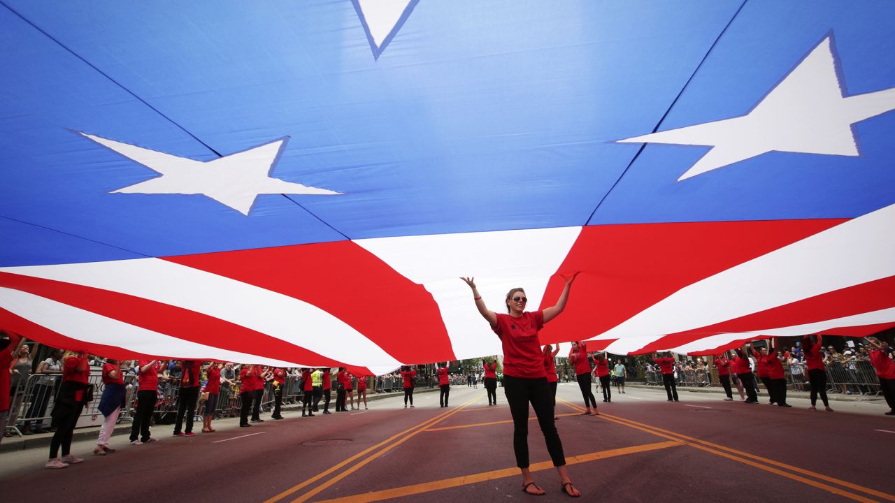 People hold up the world's largest American flag during the Chicago Memorial Day Parade on May 28. The 5,000-square-foot flag is nearly 100 years old.