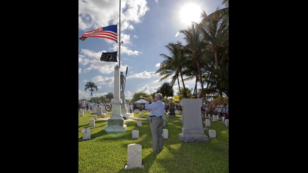 Former music teacher Jim Doepke plays taps at the conclusion of a Memorial Day ceremony in Key West, Florida.