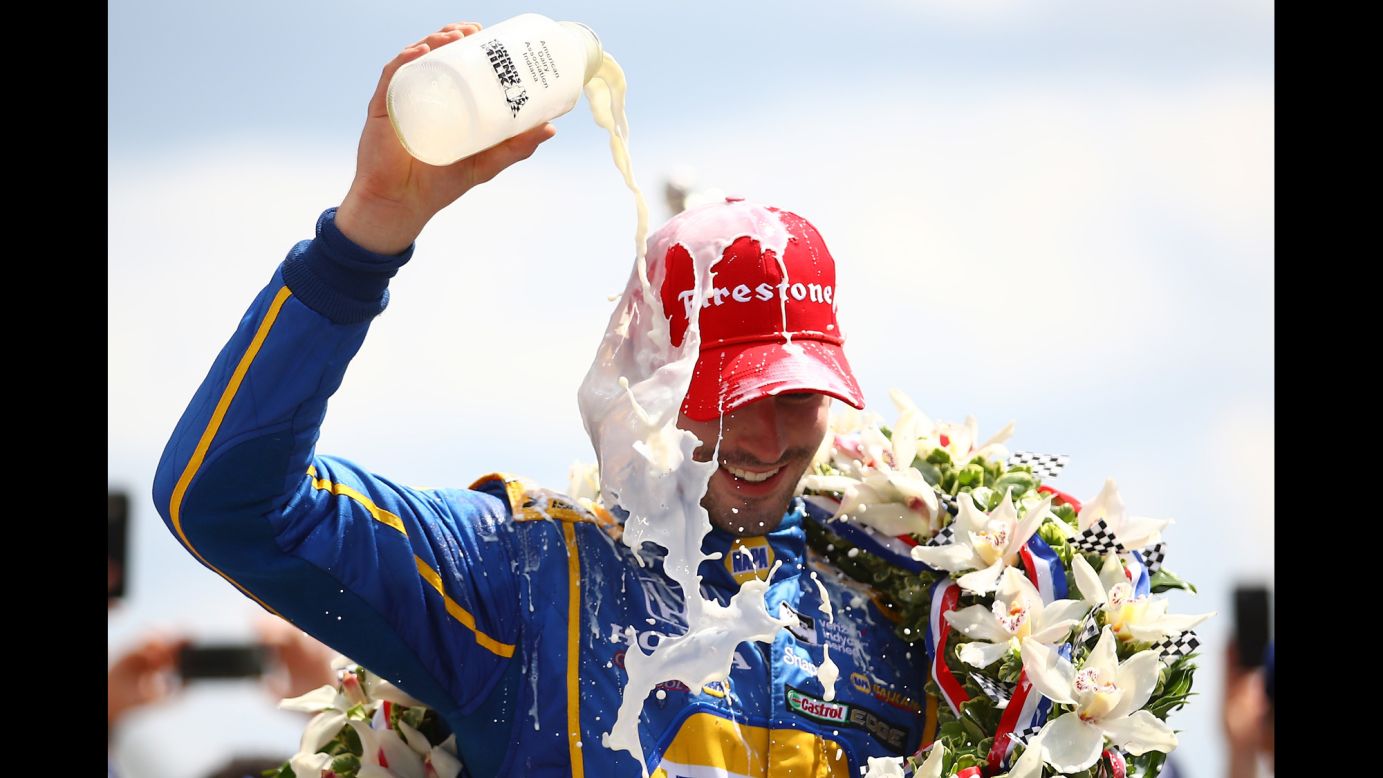 Alexander Rossi celebrates with the traditional bottle of milk after winning the Indianapolis 500 on Sunday, May 29. The rookie ran out of fuel on the last lap but held on for the victory.